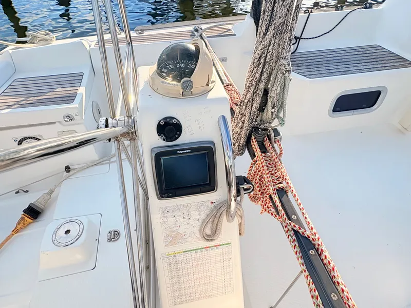 Slide: The Image of The cockpit of a 2007 Beneteau First 36.7 with compass, navigation system, and ropes. - 8