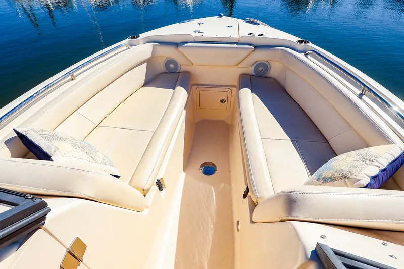 Slide: The Image of Spacious seating area on 2016 Grady-White Freedom 275 boat, featuring comfortable cushions and scenic water view. - 17