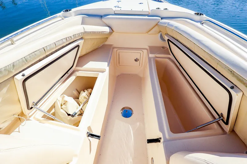Slide: The Image of 2016 Grady-White Freedom 275 boat interior with open storage compartments. - 24