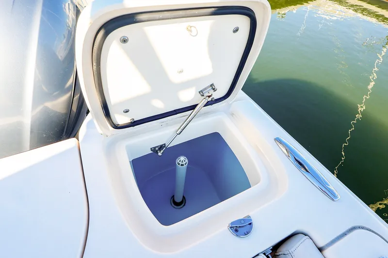 Slide: The Image of Open storage compartment on 2016 Grady-White Freedom 275 boat, near water. - 22
