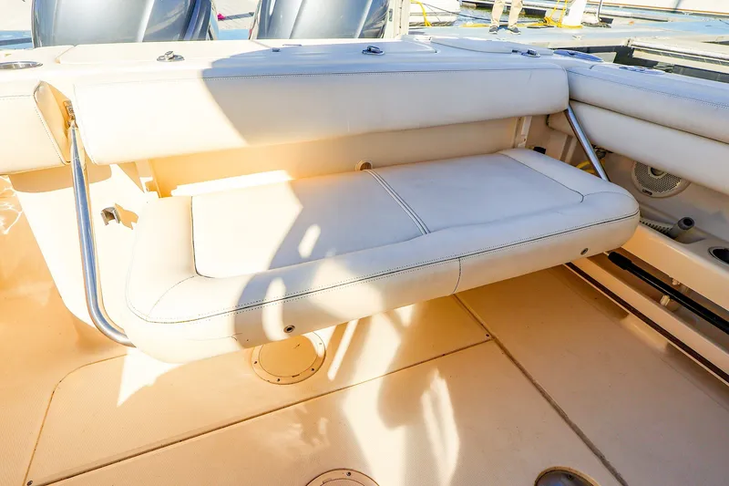 Slide: The Image of 2016 Grady-White Freedom 275 boat interior with foldable seating and sunlit deck. - 20