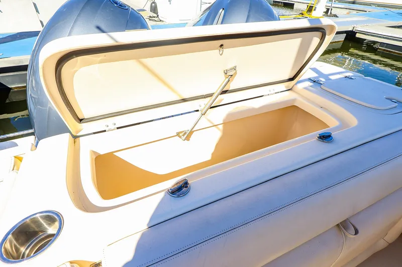 Slide: The Image of Open storage compartment on a 2016 Grady-White Freedom 275 boat, docked at a marina. - 23