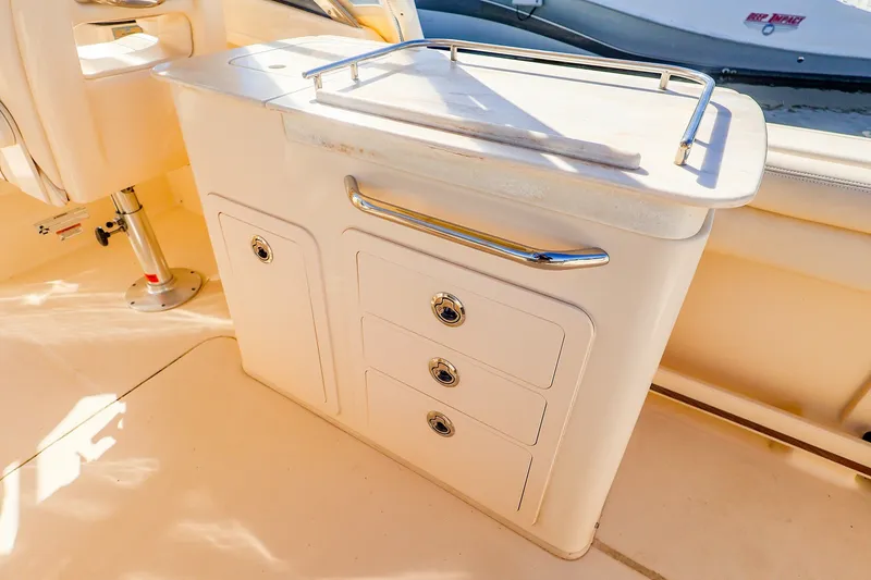 Slide: The Image of 2016 Grady-White Freedom 275 boat interior with storage drawers and countertop. - 14