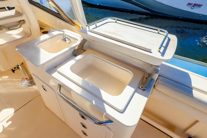 Slide: The Image of 2016 Grady-White Freedom 275 boat interior with sink and storage area. - 15