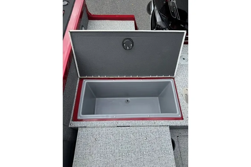 Slide: The Image of Open storage compartment on 2023 Tracker Targa V-19 Combo boat, featuring gray interior. - 15