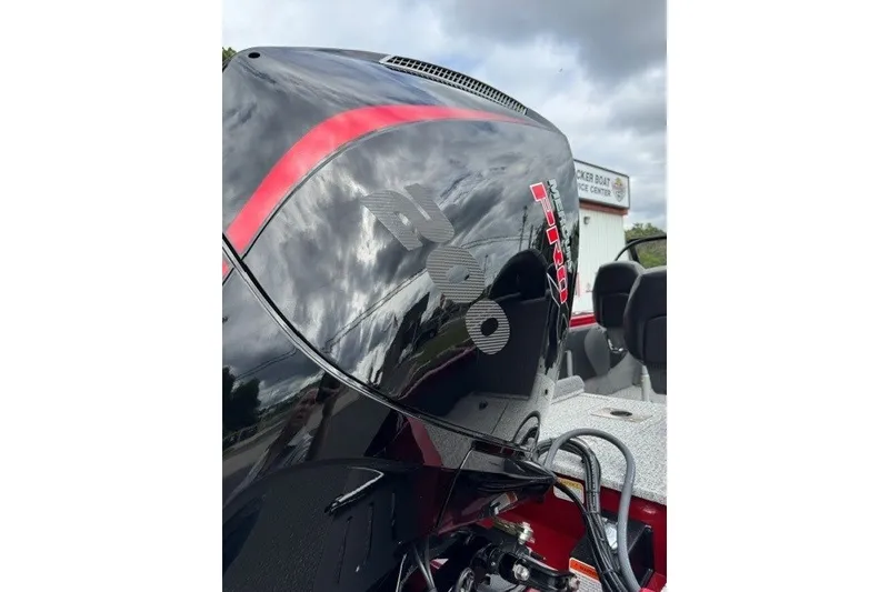 Slide: The Image of 2023 Tracker Targa V-19 Combo boat engine with sleek black and red design. - 13