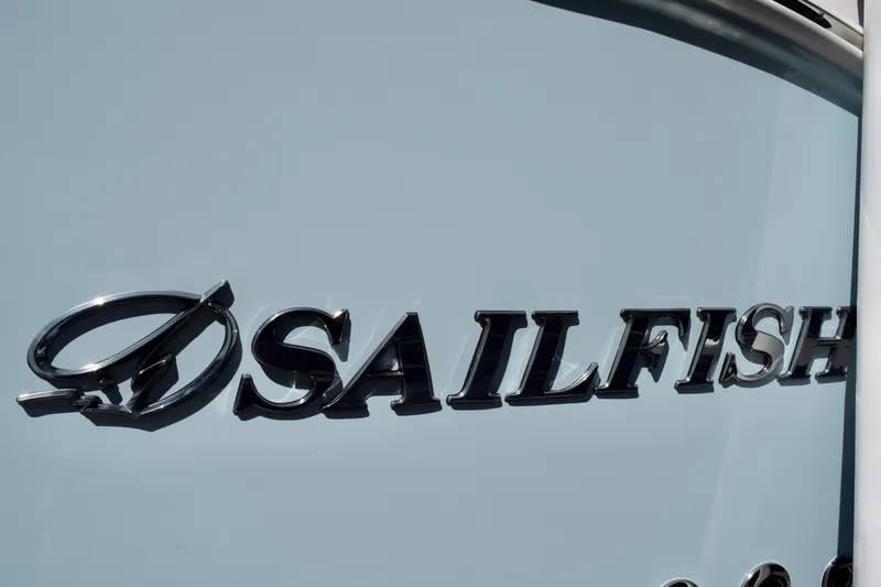 Slide: The Image of Close-up of Sailfish 252 CC logo on 2027 model boat exterior. - 19