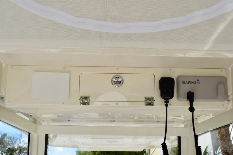 Slide: The Image of 2027 Sailfish 252 CC boat console with Garmin equipment and secure storage compartment. - 16