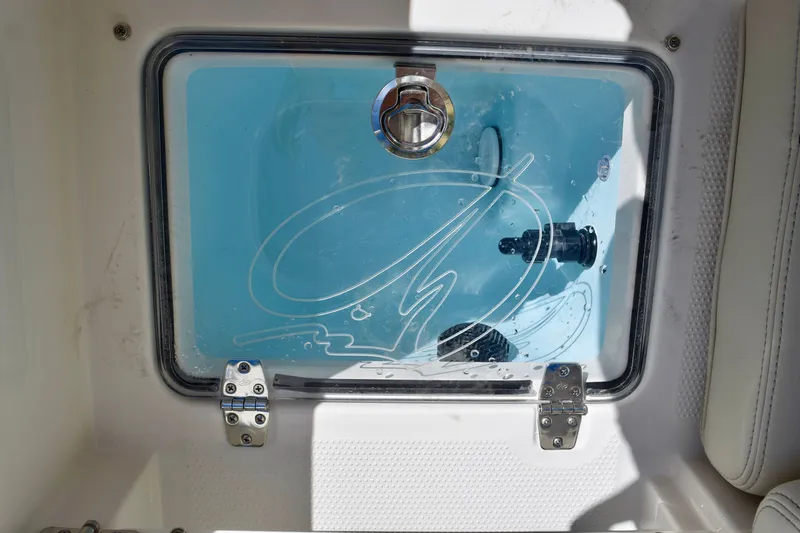 Slide: The Image of Livewell compartment on 2027 Sailfish 252 CC boat with clear lid and latch. - 18