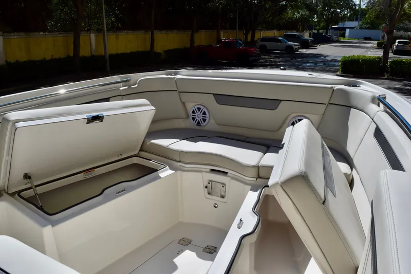 Slide: The Image of 2027 Sailfish 252 CC boat interior with open storage compartments and cushioned seating. - 14