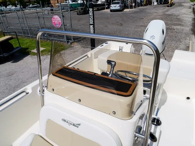 Slide: The Image of The image shows the cockpit of a Bulls Bay 2000 boat with a helm and seating area. - 20
