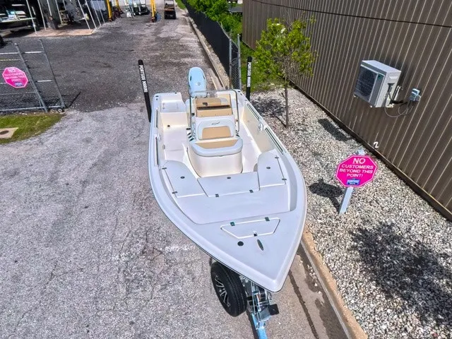 Slide: The Image of A 2027 Bulls Bay 2000 boat on a trailer, featuring an open deck design and seating. - 16