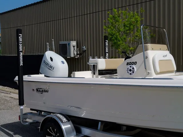 Slide: The Image of A 2027 Bulls Bay 2000 boat on a trailer, featuring a Suzuki outboard motor. - 13