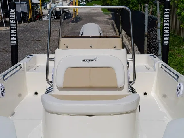 Slide: The Image of The image shows the cockpit of a Bulls Bay 2000 boat with beige and white seating area. - 32