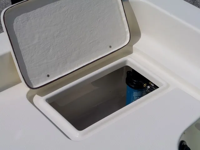 Slide: The Image of An open storage compartment on a 2027 Bulls Bay 2000 boat with a blue container inside. - 26