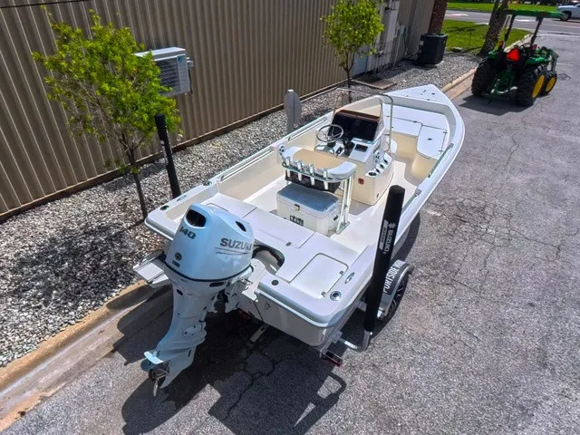 Slide: The Image of A 2027 Bulls Bay 2000 boat on a trailer next to a building. - 14