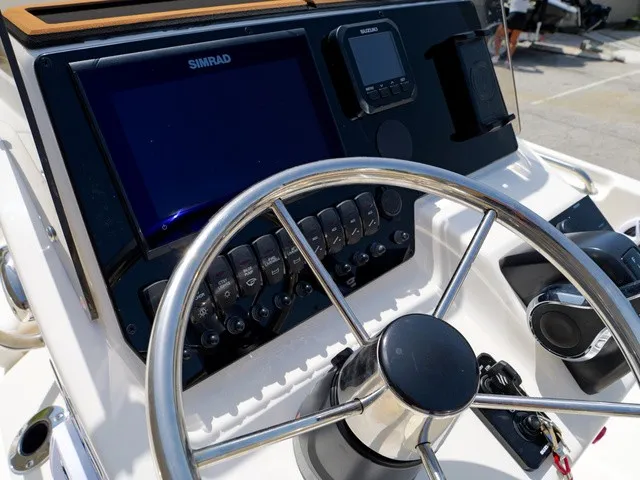 Slide: The Image of Helm of a Bulls Bay 2000 boat with modern navigation equipment and stainless steel steering wheel. - 19