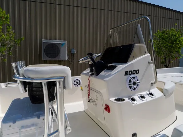 Slide: The Image of The image shows the helm of a 2027 Bulls Bay 2000 boat with a white seat. - 35