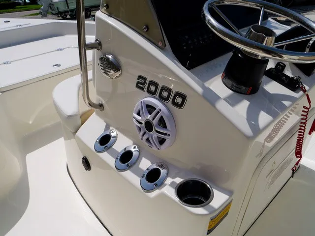 Slide: The Image of The image shows the helm of a Bulls Bay 2000 boat with steering wheel and cup holders. - 25