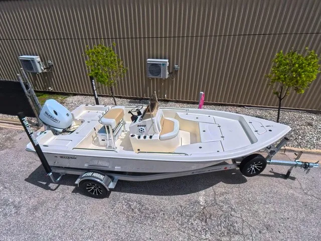 Slide: The Image of A 2027 Bulls Bay 2000 boat on a trailer, featuring an outboard motor and steering console. - 1