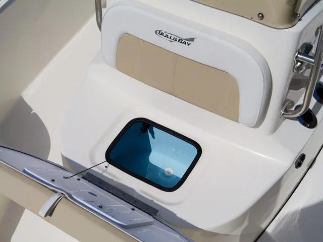Slide: The Image of The image shows the seating area of a Bulls Bay 2000 boat with a built-in blue compartment. - 21