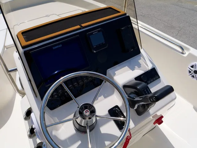 Slide: The Image of The image shows the helm of a Bulls Bay 2000 boat with modern instruments and a steering wheel. - 2