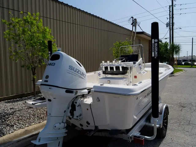 Slide: The Image of A 2027 Bulls Bay 2000 boat with a Suzuki outboard motor, parked on a trailer. - 37