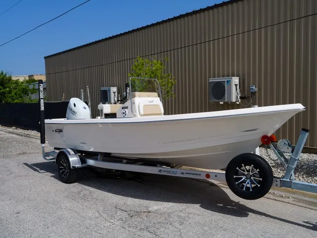 Slide: The Image of A white Bulls Bay 2000 boat from 2027 is on a trailer in front of a building. - 10