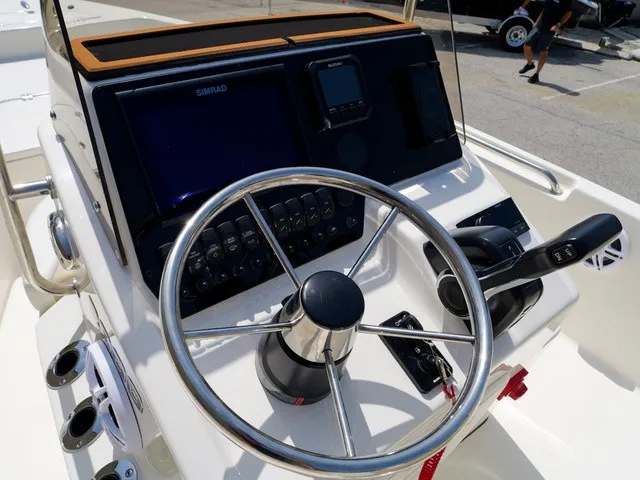 Slide: The Image of The image shows the helm of a Bulls Bay 2000 boat with modern instruments and a large steering wheel. - 7