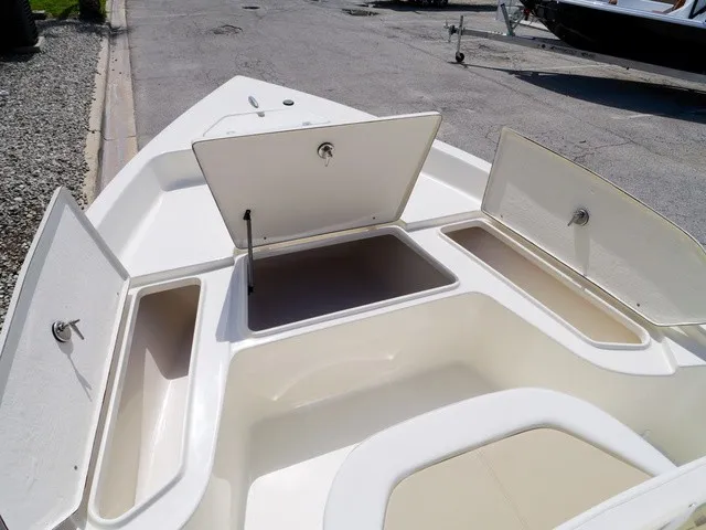 Slide: The Image of The image shows the bow of a Bulls Bay 2000 boat with open storage compartments. - 23