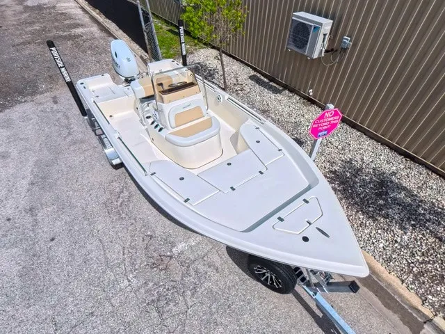 Slide: The Image of A modern Bulls Bay 2000 boat on a trailer, featuring a clean, open deck and beige seating. - 17