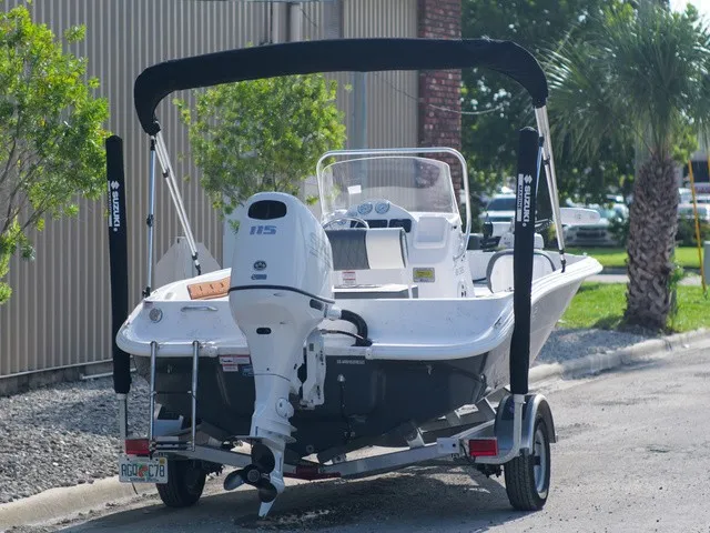 Slide: The Image of ALK2 Powerboats 18CRS 2023 with outboard motor and bimini top, parked on a trailer. - 5