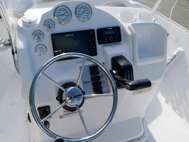 Slide: The Image of The image shows the helm of a 2023 ALK2 Powerboats 18CRS with various gauges and a steering wheel. - 10