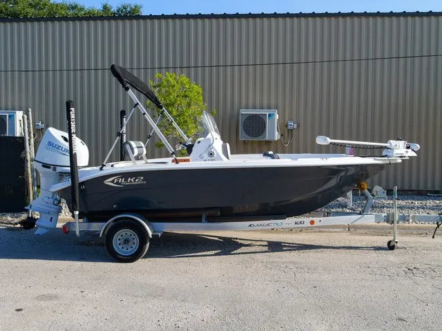 Slide: The Image of A 2023 ALK2 Powerboats 18CRS on a trailer, featuring a Suzuki engine and bimini top. - 6