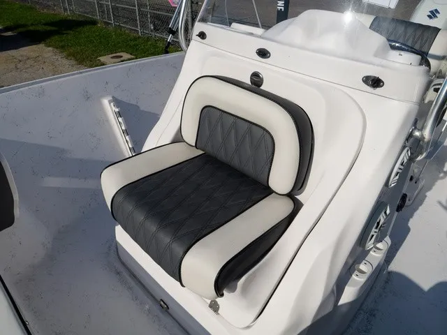 Slide: The Image of A sleek seat with black and white upholstery on a modern boat. - 8