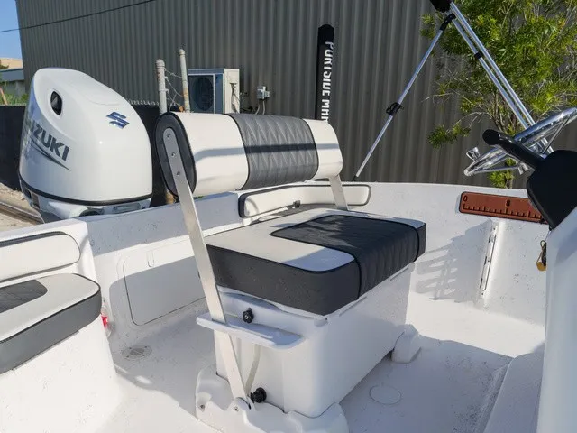Slide: The Image of The image shows the cockpit of an ALK2 Powerboats 18CRS with black and white seats and a Suzuki engine. - 4