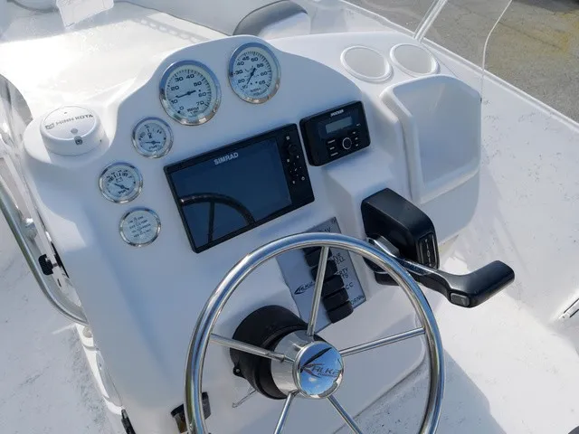 Slide: The Image of The image shows the helm of a 2023 ALK2 Powerboats 18CRS with instruments and a steering wheel. - 11