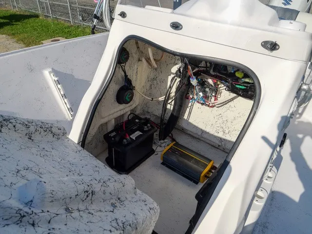 Slide: The Image of The image shows the interior of a 2023 ALK2 Powerboats 18CRS with electronics and a battery. - 12