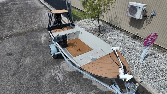 Slide: The Image of 2024 Hog Island Shallow Water 16 Skiff in gray on a trailer. - 13