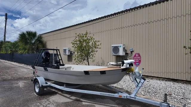 Slide: The Image of 2024 Hog Island Boat Works shallow water skiff in gray on a trailer. - 14