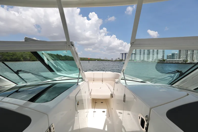 Slide: The Image of 2016 Boston Whaler 320 Vantage boat interior with waterfront cityscape view. - 9