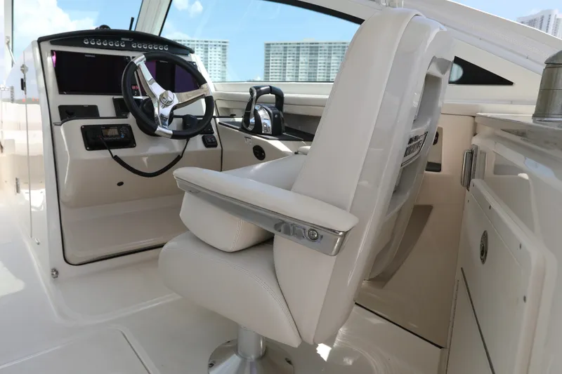 Slide: The Image of Interior of a 2016 Boston Whaler 320 Vantage boat, featuring a sleek helm and captain's chair. - 16