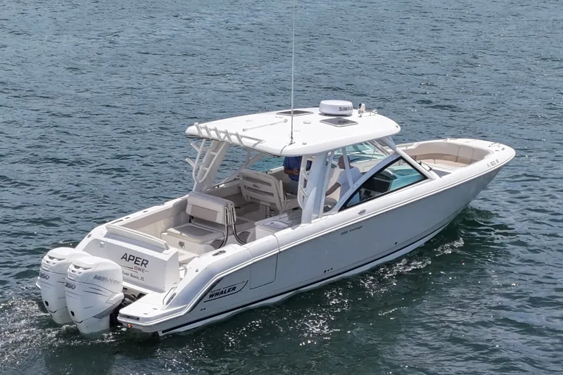 Slide: The Image of 2016 Boston Whaler 320 Vantage boat cruising on open water. - 4
