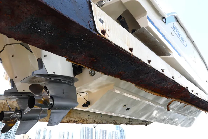 Slide: The Image of 2016 Boston Whaler 320 Vantage boat hull and propellers, showing rust and wear. - 6