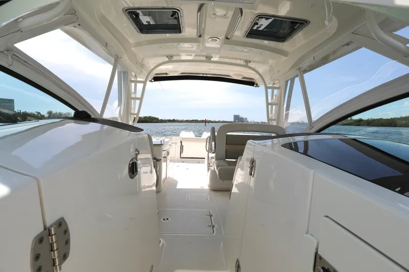 Slide: The Image of Interior view of a 2016 Boston Whaler 320 Vantage boat, showcasing spacious seating and sleek design. - 10