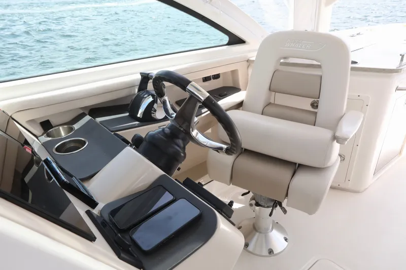 Slide: The Image of Helm of 2016 Boston Whaler 320 Vantage with luxurious seating and controls. - 17