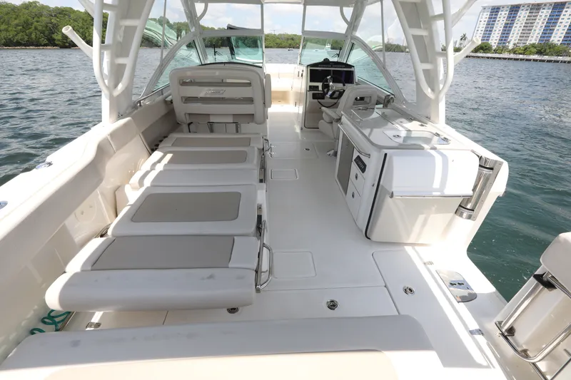 Slide: The Image of 2016 Boston Whaler 320 Vantage boat interior with seating and helm, on calm water. - 13