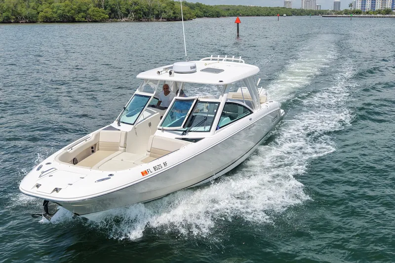 The Image of 2016 Boston Whaler 320 Vantage cruising on a scenic waterway. - 2