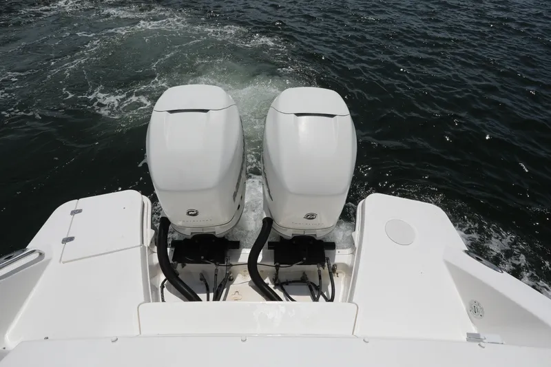 Slide: The Image of Twin outboard engines on a 2016 Boston Whaler 320 Vantage boat in water. - 20