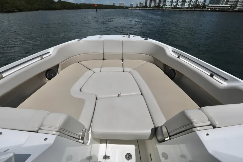 Slide: The Image of 2016 Boston Whaler 320 Vantage boat interior with spacious seating on calm water. - 7